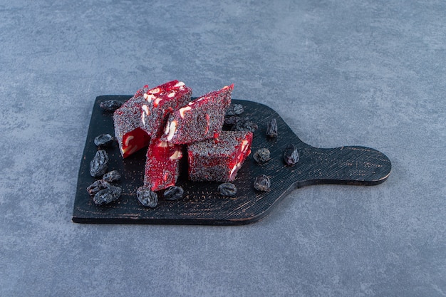 Raisins and Turkish delights in a cutting, on the marble surface