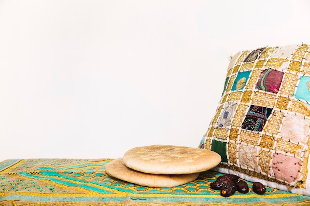 Ramadan concept with arab bread and cushion