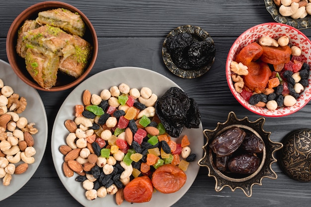 Free photo ramadan snack with traditional dried fruits; dates and baklava on table