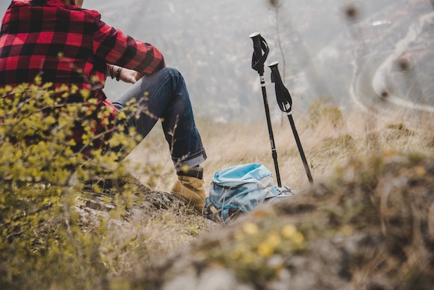 Rambler sitting next to his backpack and his walking sticks