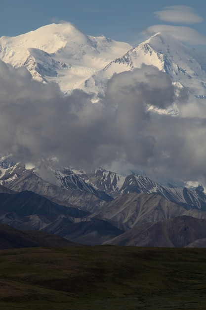 Range of beautiful high rocky mountains covered with snow in Alaska