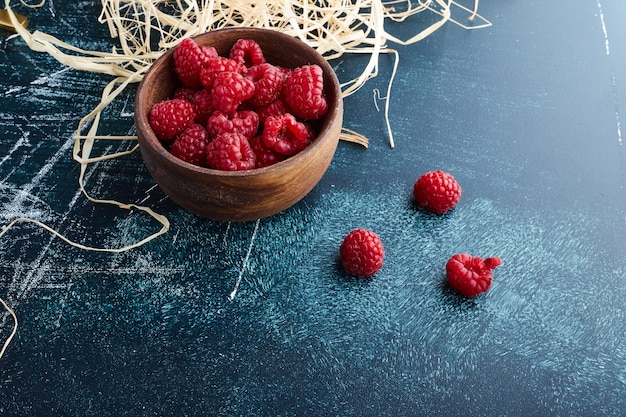 Raspberries in a wooden cups. 