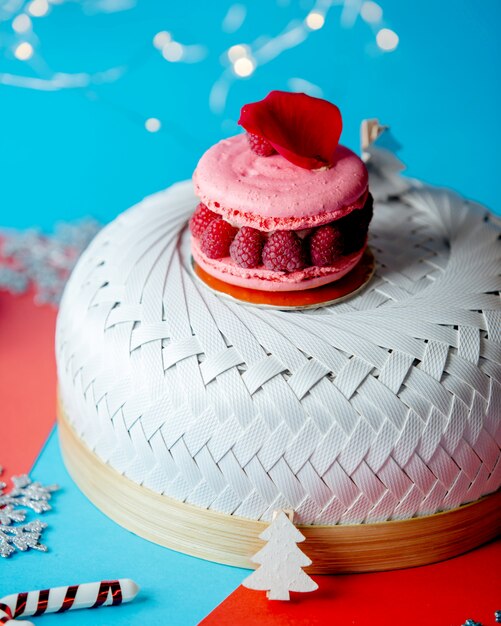 Raspberry macaron with raspberries topped with red rose petal