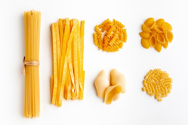 Raw assortment of pasta on white background