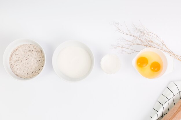 Raw baking ingredient arranged in row over white surface