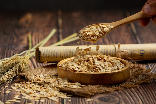 Free photo raw barley grain in wooden background