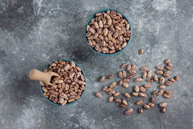 Raw bean grains displayed in bowls.