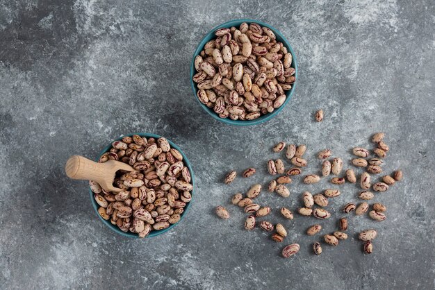 Raw bean grains displayed in bowls.