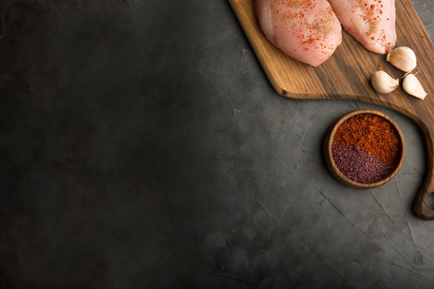 Raw chicken breast with garlic and spices