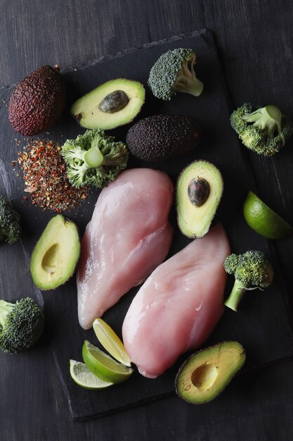 Raw chicken breasts with vegetables