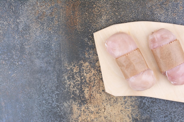 Raw chicken breasts on wooden board. High quality photo