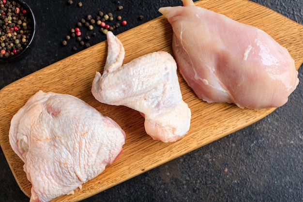 Raw chicken chunks different parts of a poultry carcass breast wings thigh chicken legs