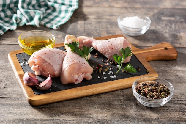 Raw chicken meat legs with spices and herbs