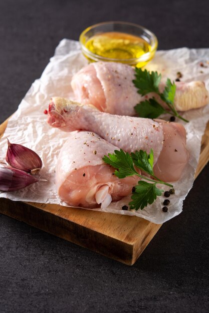 Raw chicken meat legs with spices and herbs