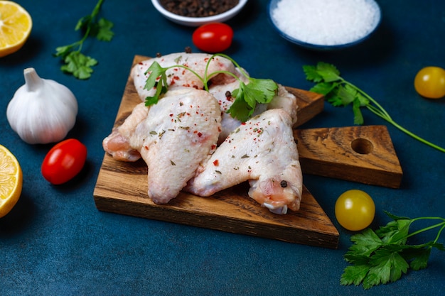 Raw chicken wings on cutting board. Top view