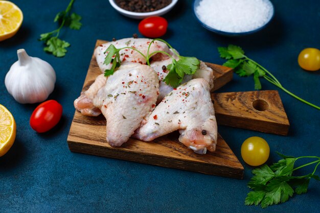 Raw chicken wings on cutting board. Top view