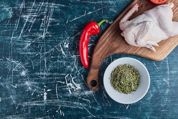 Free photo raw chicken with herbs and spices.