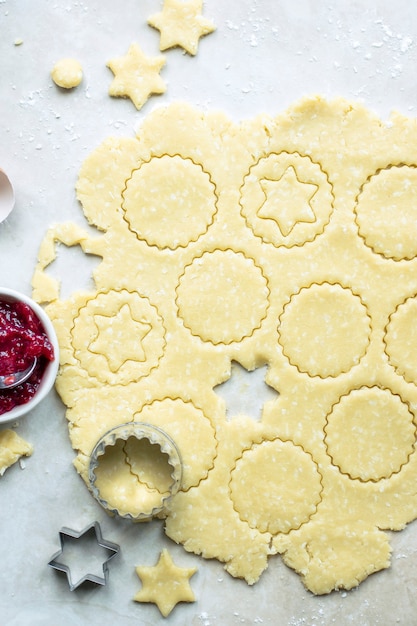 Raw cookies being cut with a star cookie cutter