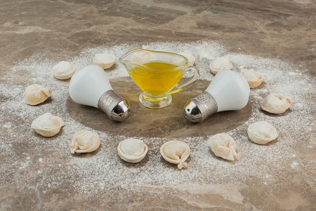 Raw dumplings with oi, salt, pepper and flour .