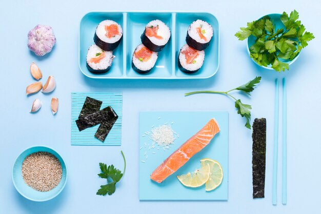 Raw fish sushi rolls with soya souce on table