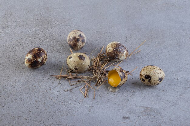 Raw fresh quail eggs placed on a stone table.