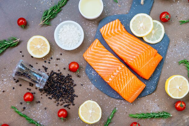 Raw and fresh salmon meat fillet on black stone slate