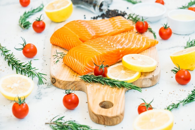 Raw and fresh salmon meat fillet on wooden cutting board