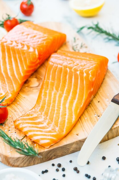 Raw and fresh salmon meat fillet on wooden cutting board