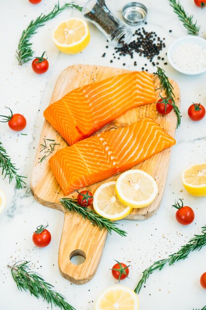 Raw and fresh salmon meat fillet on wooden cutting board