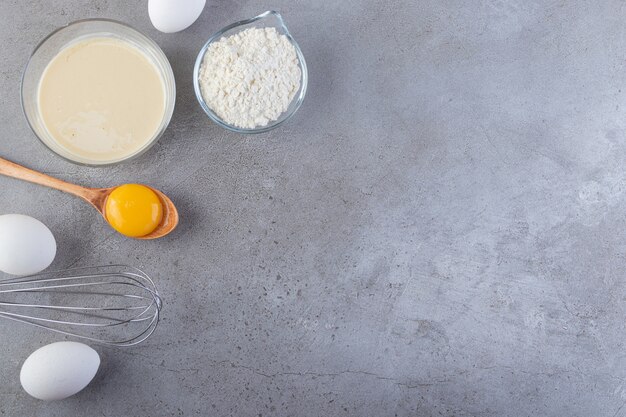 Raw fresh white chicken eggs placed on a stone background.