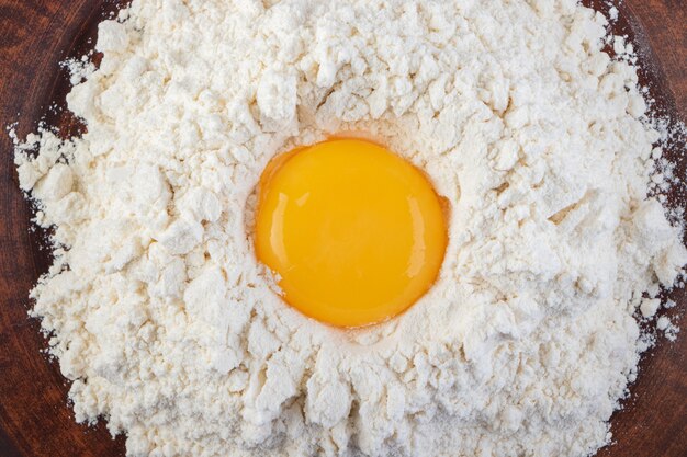 Raw fresh white chicken eggs placed on a stone surface. 