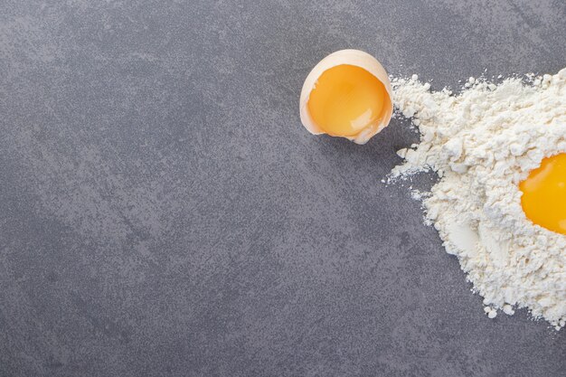 Raw fresh white chicken eggs placed on a stone table.