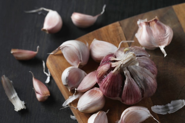 Raw garlic on cutting board