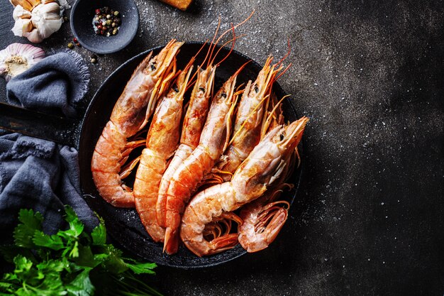Raw giant shrimps on dark table