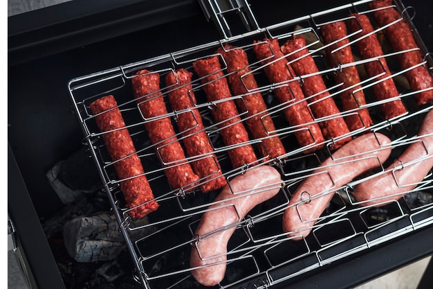 Raw homemade sausages on grill