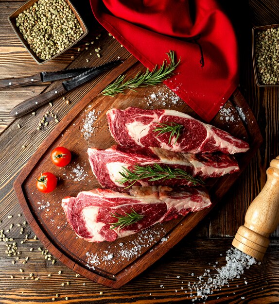 Raw meat slices topped with herbs and salt