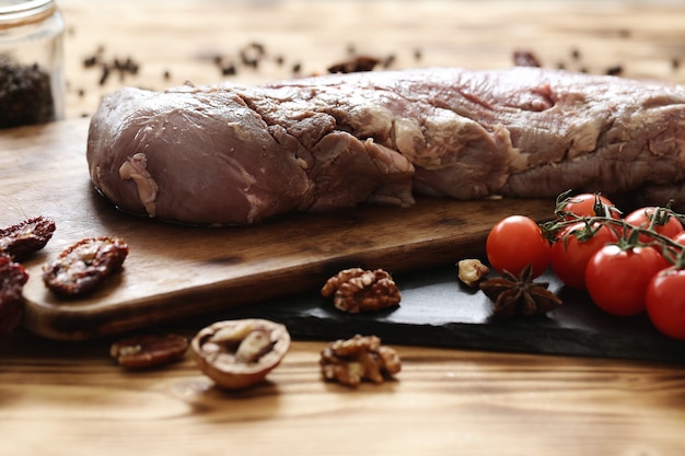 Carne cruda con ingredienti per cucinare il pasto