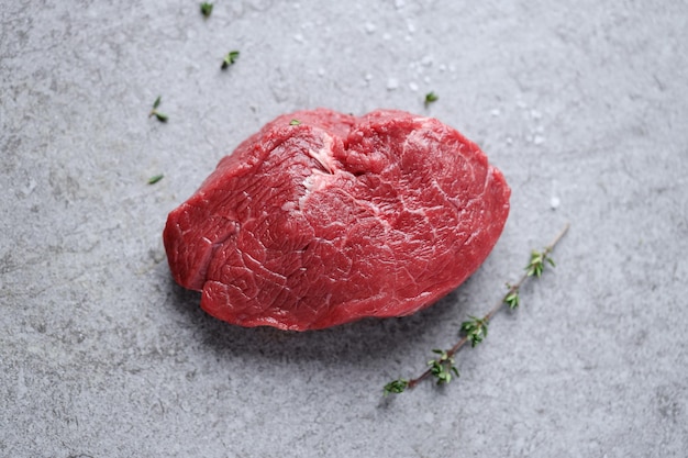 Free photo raw meat with spices and herbs on table