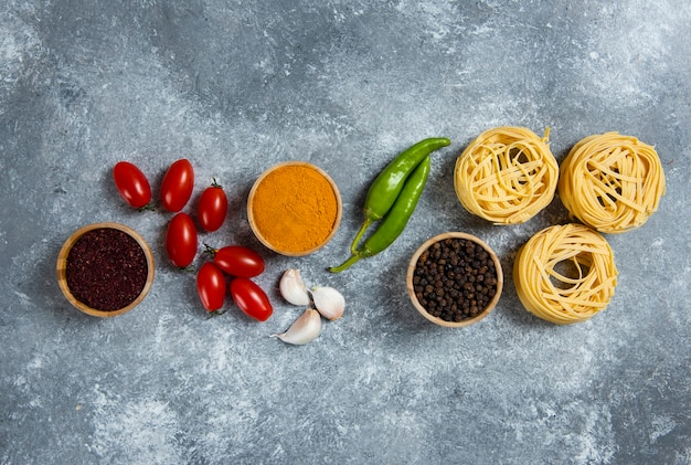 Raw nest pasta with spices and vegetables.