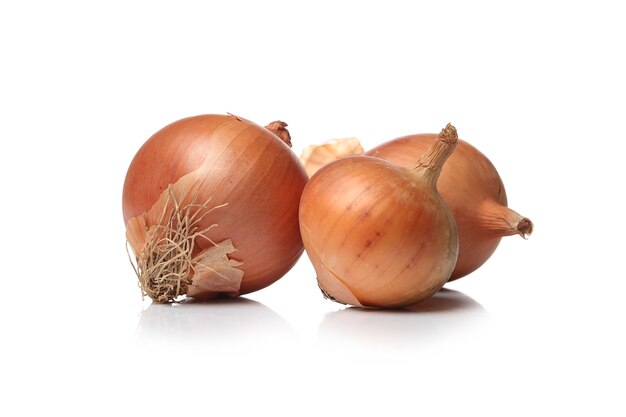 Raw onions on a white surface
