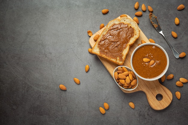 Free photo raw organic almond butter on dark background