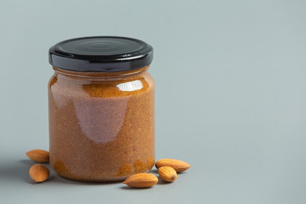 Raw Organic Almond Butter on gray background