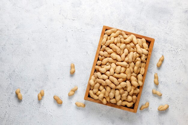 Raw organic peanuts in shell.