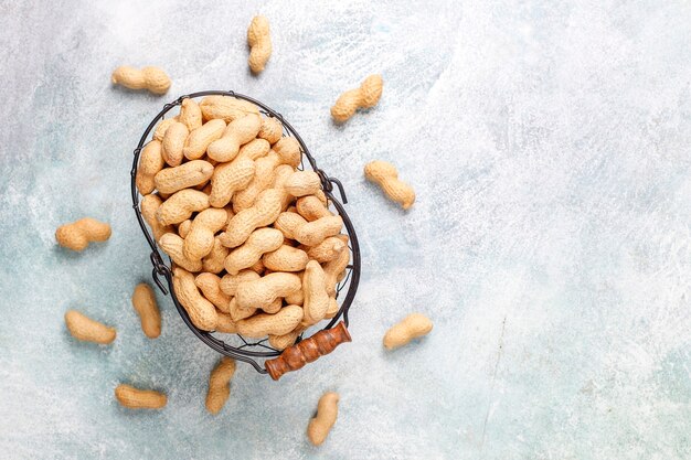 Raw organic peanuts in shell.