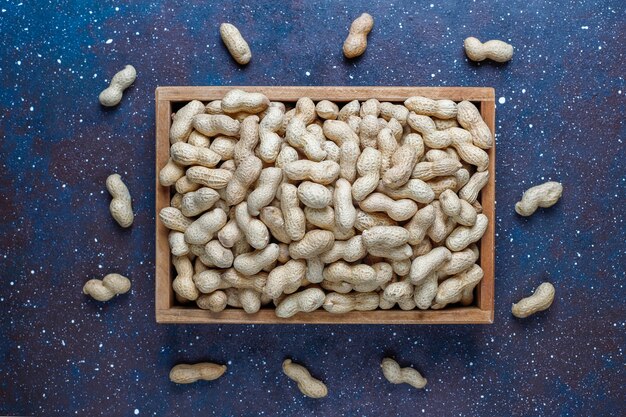 Raw organic peanuts in shell.