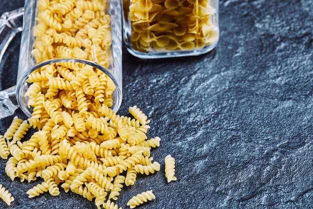 Raw pasta inside the a glass jar.