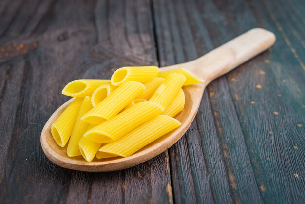 Raw pasta on spoon