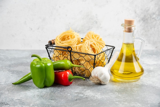 Raw pasta varieties with garlic, chili peppers and olive oil.