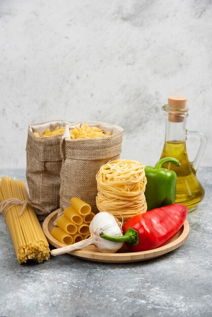 Raw pasta varieties with garlic, chili peppers and olive oil.