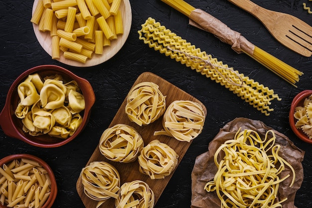 Raw pasta in various kitchenware